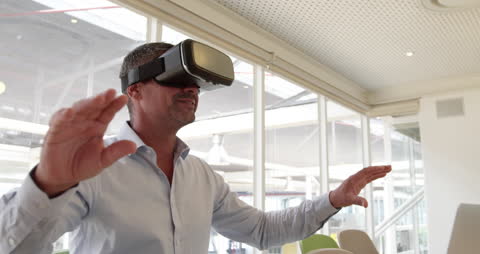 Mature Businessman Enjoying Virtual Reality Experience in Modern Office