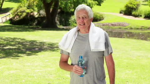 Active Senior Man Relaxing in Park After Exercise