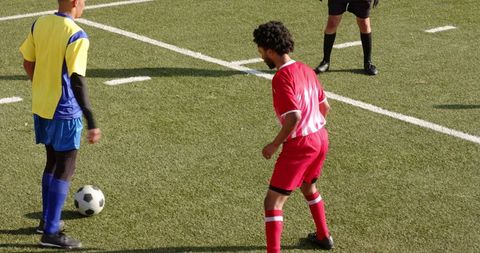 Soccer Players Preparing for Kickoff on green grass Field