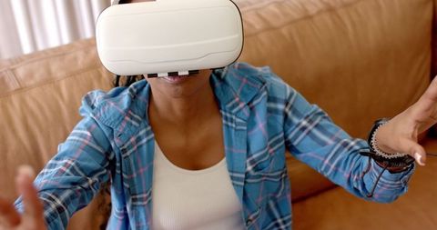 Immersive virtual reality experience by young woman in casual attire
