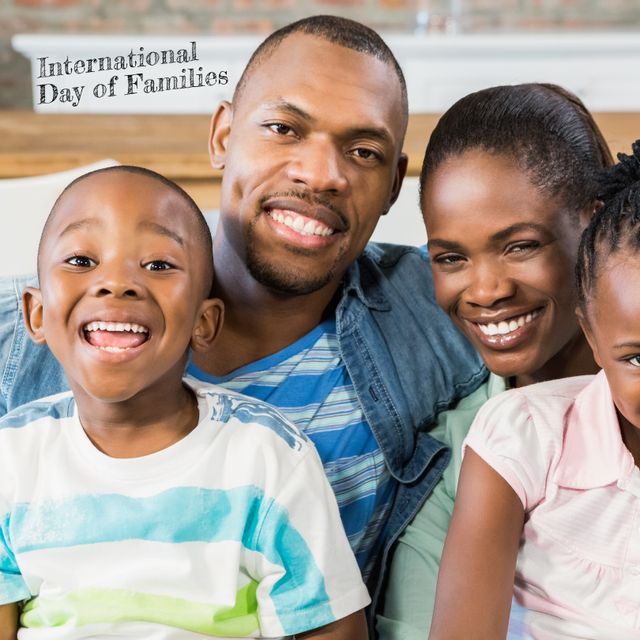 Happy African American family is enjoying leisure time together at home, smiling and showing close-knit family bonds. Perfect for representing family unity, love, and celebrations like International Day of Families, family gatherings, and home life. Utilizable in awareness campaigns, family-related promotions, and advertisements that highlight familial ties and happiness.