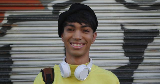 Smiling Young Man with Headphones Wearing Urban Streetwear - Download Free Stock Images Pikwizard.com