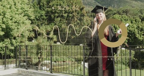 Graduating woman on balcony celebrating degree while calling and holding diploma