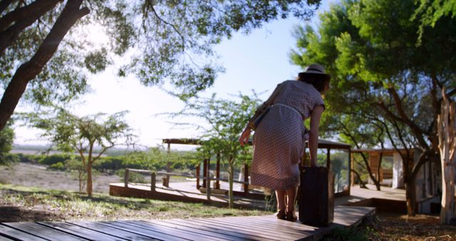 Woman in Summer Dress Arriving at Relaxing Countryside Cabin Retreat - Download Free Stock Images Pikwizard.com