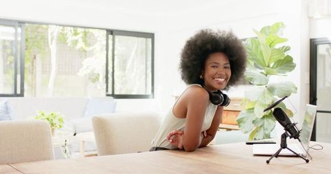 African American Woman Podcast Host with Laptop and Microphone at Home Desk