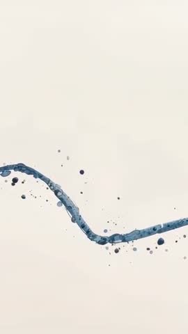 Vertical cerulean liquid ribbon flowing and shedding droplets on pale paper background