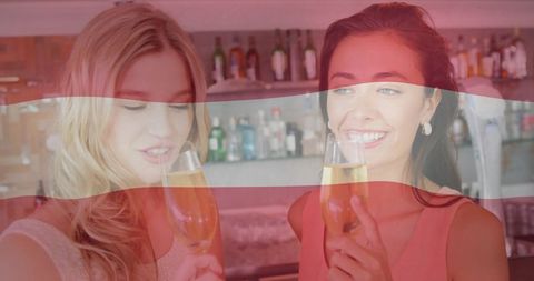 Elegant women celebrating with champagne at upscale bar