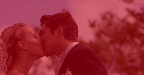 Young Couple Sharing Romantic Wedding Kiss Outdoors