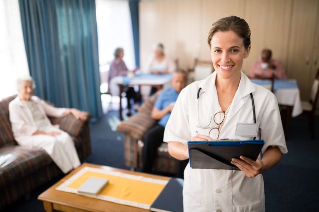 Smiling female doctor standing with file at nursing home