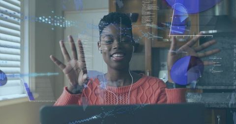 Smiling woman waving in virtual meeting with data visualization overlays and charts