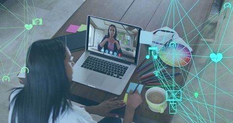 Woman Taking Notes During Virtual Meeting in Home Office