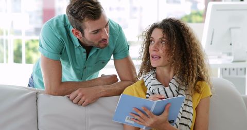 Two Creative Professionals Collaborating in Modern Office