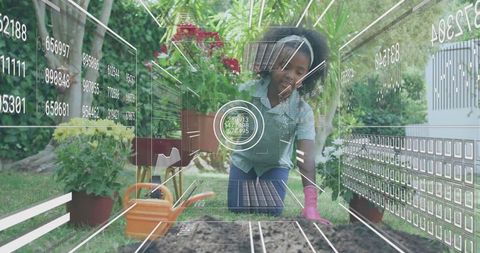 Girl Planting in Raised Garden Bed Creating Sustainable Backyard