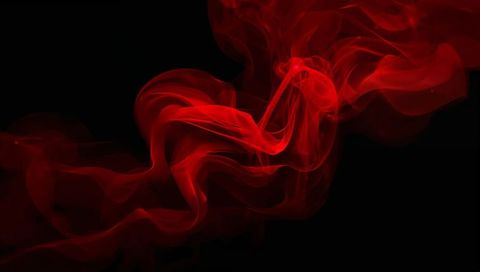 Red smoke ribbon flowing over deep black canvas, abstract scarlet vapor for design