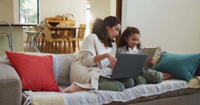 Mother and Daughter Using Laptop and Tablet on Living Room Sofa - Download Free Stock Images Pikwizard.com