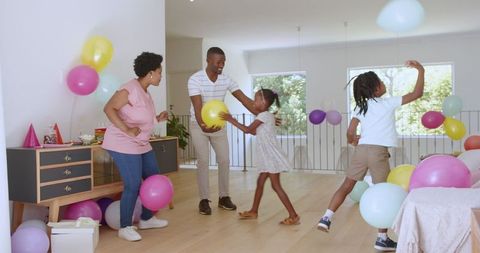 Family fun balloon party in bright modern home