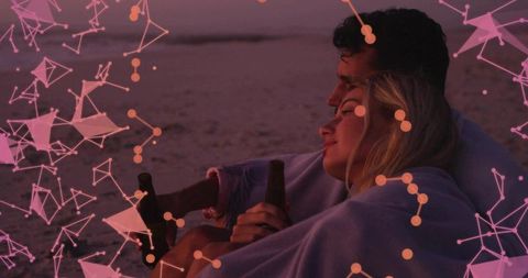 Couple Enjoying Sunset with Beer on Serene Beach