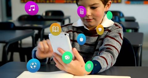 Engaged schoolboy connecting with digital learning apps