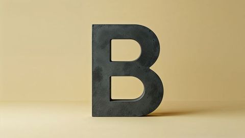 Large 3d uppercase letter b sculpture on beige background
