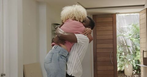 Joyful Couple Embracing in Modern Home Entryway