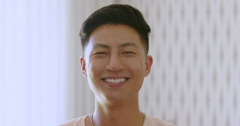 Cheerful Asian Groom Joyfully Embracing Wedding Traditions