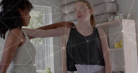 Teenage Girls Practicing Yoga with Digital Network Overlay