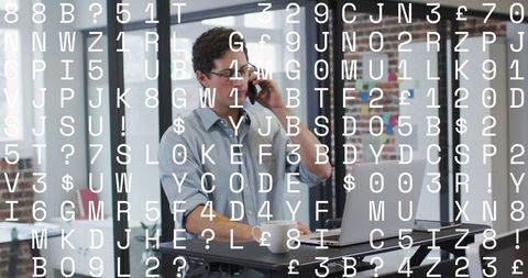 Businessman Analyzing Data on Laptop While on Phone