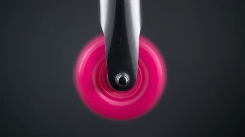Spinning magenta caster wheel revealing axle head while fork tilts left