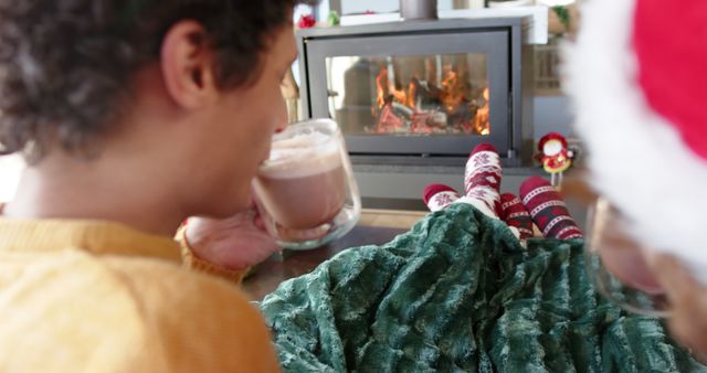 Family Enjoying Hot Chocolate by Fireplace During Christmas - Download Free Stock Images Pikwizard.com