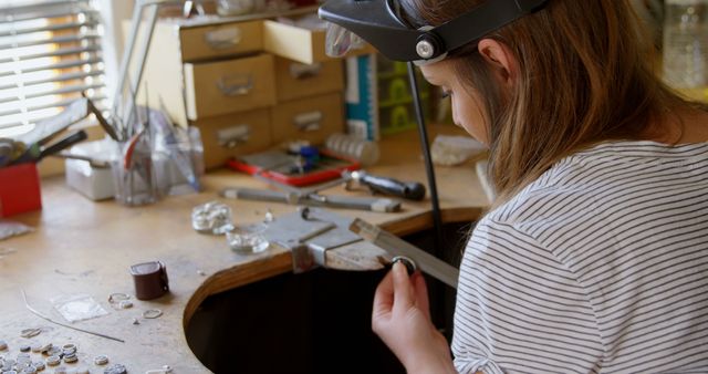 Caucasian Woman Crafting Jewelry at Workbench with Tools - Download Free Stock Images Pikwizard.com