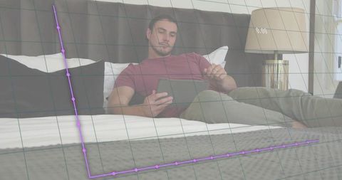 Reclining man using tablet in bedroom viewing holographic analytics graph overlay interface