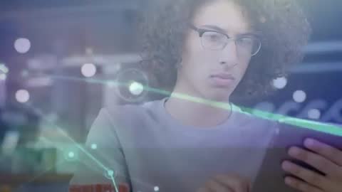 Young Man Using Tablet to Access Digital Data Network in Cafe