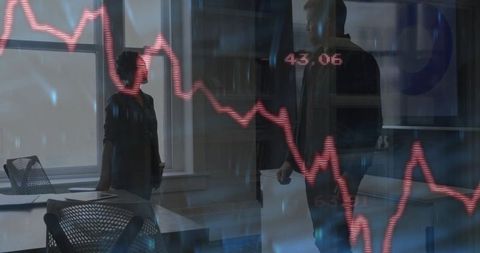 Colleagues Analyzing Financial Graph in Modern Office