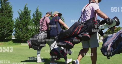 Four golfers walking carrying bags on sunlit fairway wearing face masks and caps