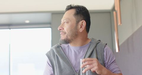 Senior Man Relaxing with Drink in Contemporary Urban Lounge