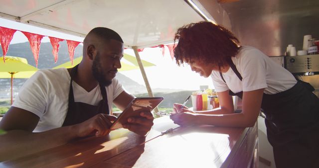 Food Truck Staff Discussing Orders Using Digital Tablet - Download Free Stock Images Pikwizard.com