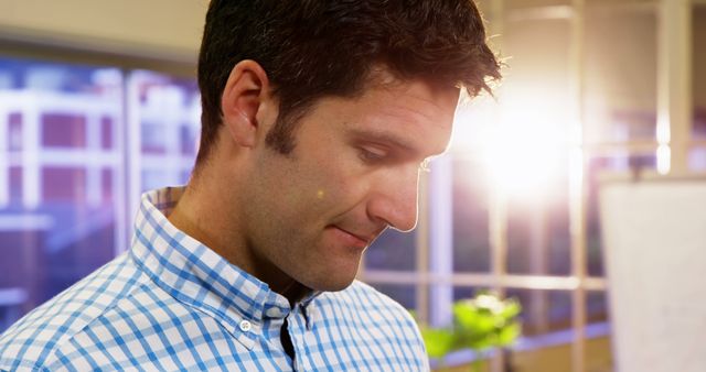 Thoughtful Man in Casual Shirt Reflecting Near Sunrise Window - Download Free Stock Images Pikwizard.com