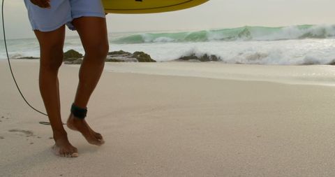 Surfer Walking with Surfboard on Sandy Beach Shore