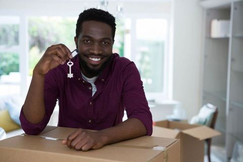 Excited Man Holding Key Celebrating New Home Ownership
