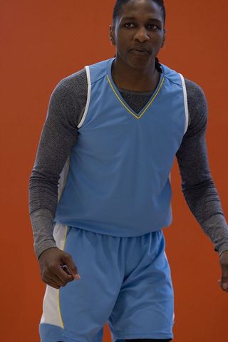 Determined Basketball Player in Blue Jersey Ready for Action