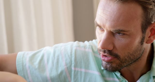 Man in Casual Shirt Engaging in Serious Conversation, Daylight Indoors - Download Free Stock Images Pikwizard.com