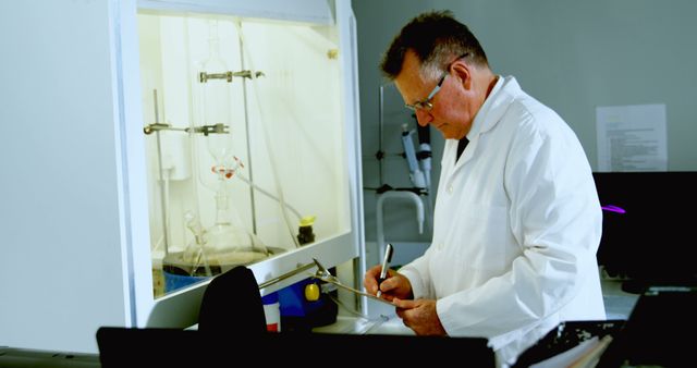 Senior Scientist Writing Notes in Laboratory - Download Free Stock Images Pikwizard.com