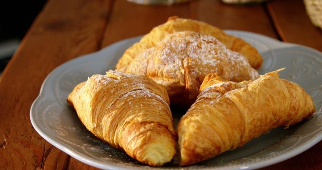 Plate with croissants on table in cafe 4k
