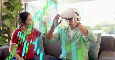 Man exploring virtual stock market with vr headset while woman reacting in living room