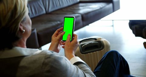 Traveler Rampage Communicates Using Smartphone at Busy Port - Download Free Stock Images Pikwizard.com