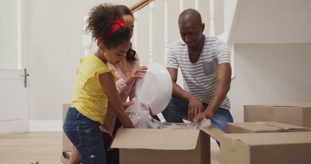 Happy Family Unpacking Together in New Home - Download Free Stock Images Pikwizard.com