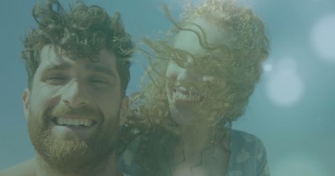 Couple Posing Playfully Underwater Smiling
