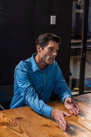 Businessman Gesturing During Meeting in Modern Office