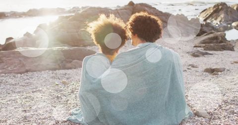 Romantic Couple Embracing on Sunny Beach in Blanket - Download Free Stock Images Pikwizard.com