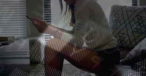 Woman Focusing on Smartphone in Serene Home Interior